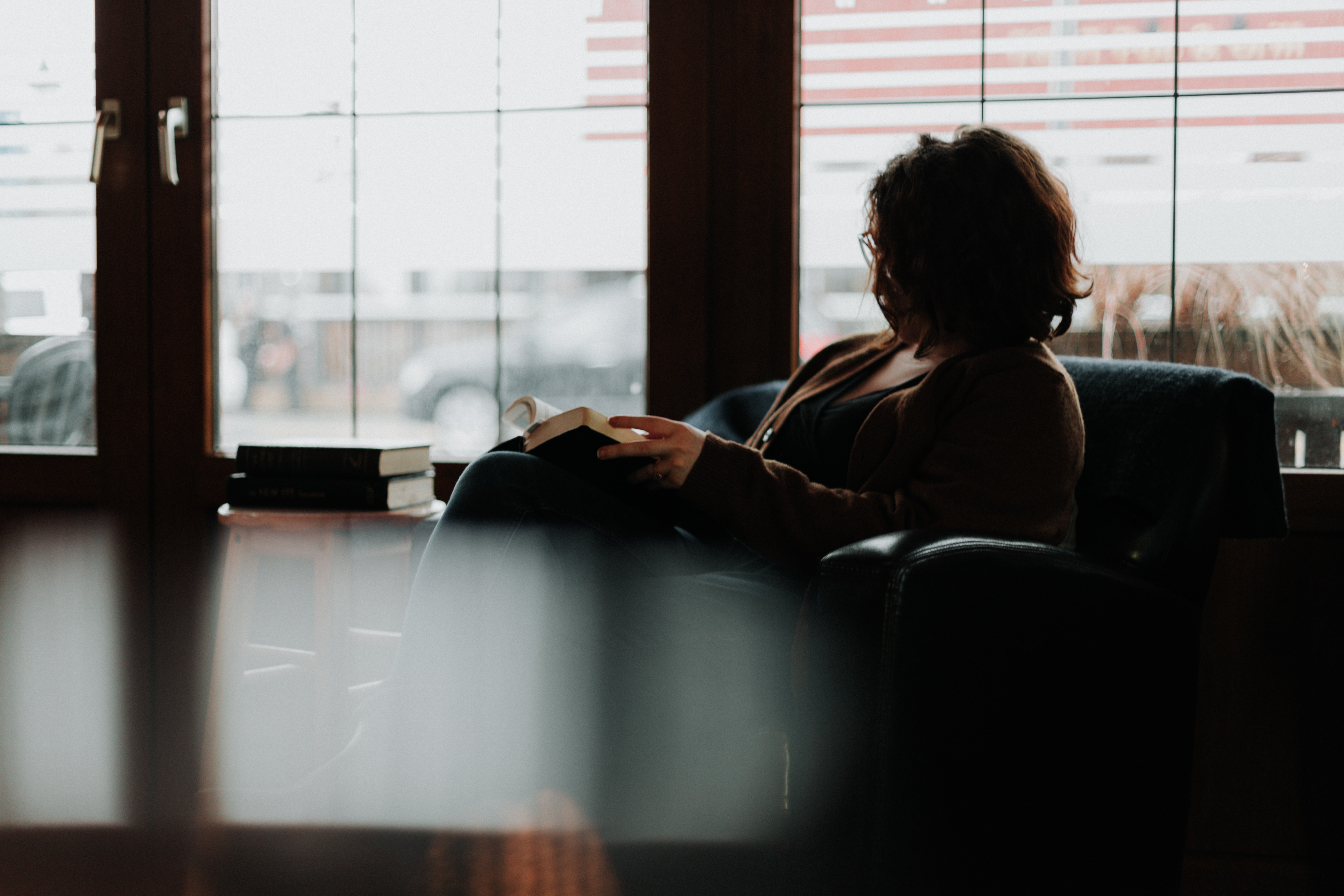 A picture of a woman relaxing with a book. She does not need to worry about taxes.